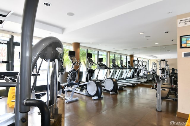 workout area featuring expansive windows and recessed lighting