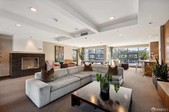 living area featuring light carpet, visible vents, beamed ceiling, a fireplace, and recessed lighting