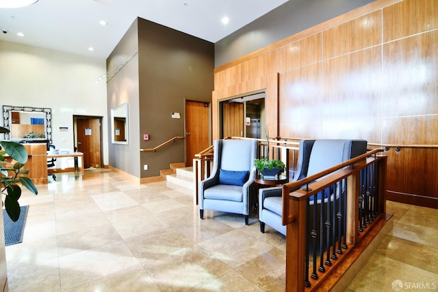 interior space with a high ceiling, stairway, and recessed lighting