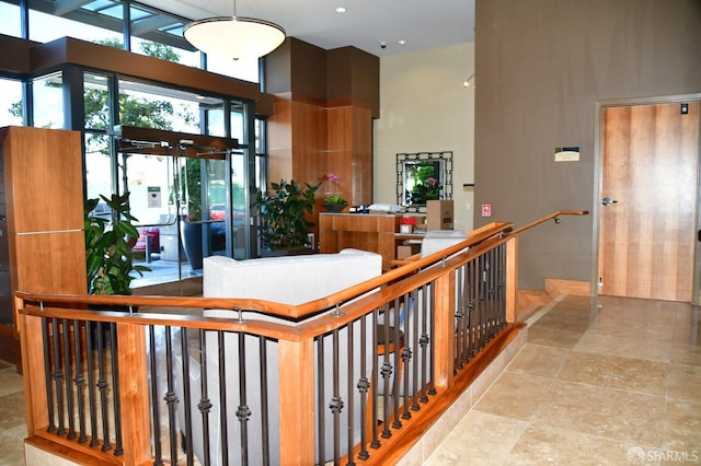 interior space featuring a towering ceiling and an upstairs landing