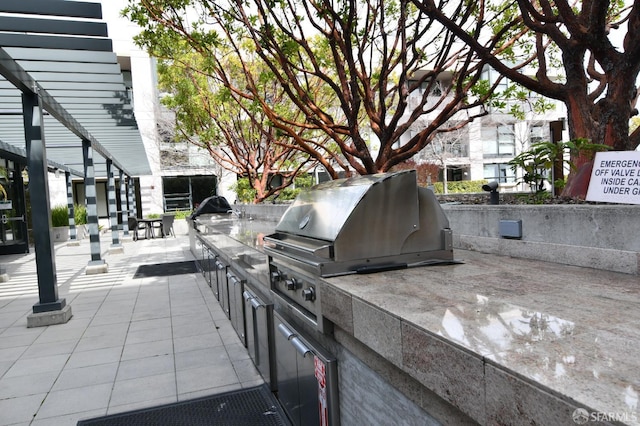 view of patio featuring exterior kitchen and area for grilling