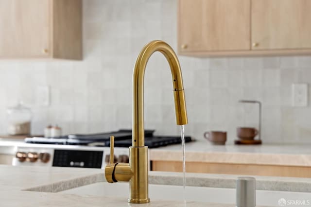 room details featuring light brown cabinets and tasteful backsplash