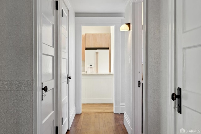 hallway with hardwood / wood-style flooring