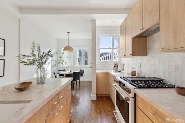 kitchen with light brown cabinetry, dark hardwood / wood-style flooring, high end white range oven, and decorative light fixtures