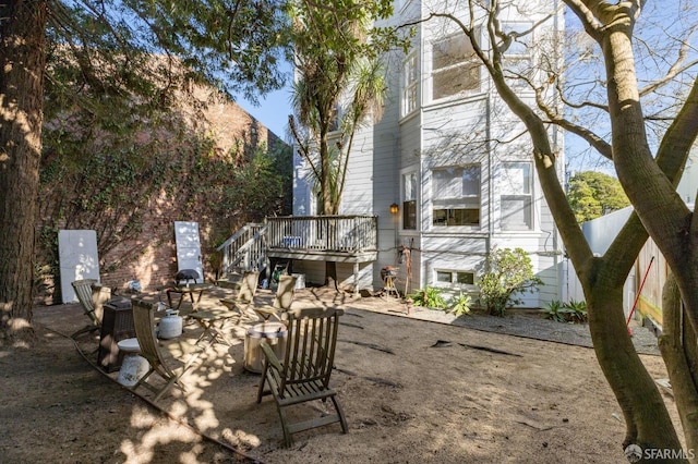 exterior space featuring a wooden deck and a patio area