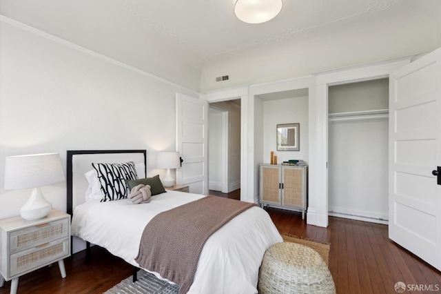 bedroom featuring a closet and dark wood-type flooring