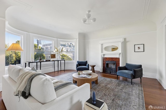 living room featuring dark wood-type flooring and a fireplace