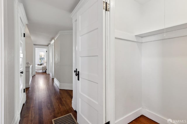 hallway featuring dark hardwood / wood-style flooring and ornamental molding