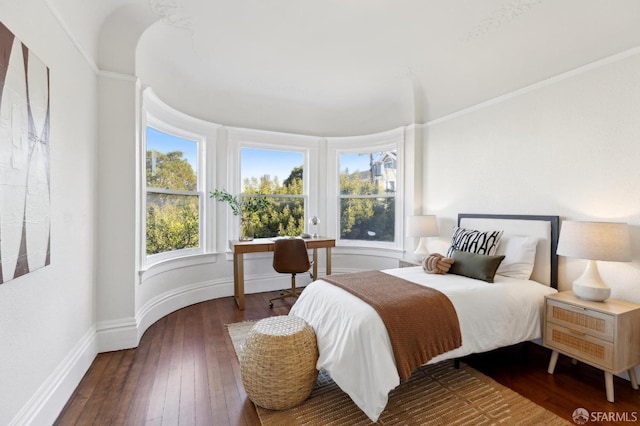 bedroom with dark wood-type flooring and ornamental molding