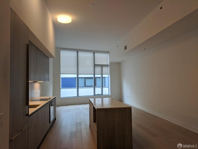 kitchen with light hardwood / wood-style floors and a kitchen island