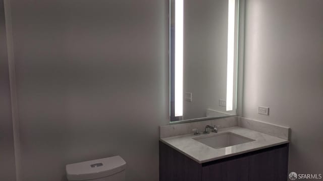 bathroom featuring vanity and toilet