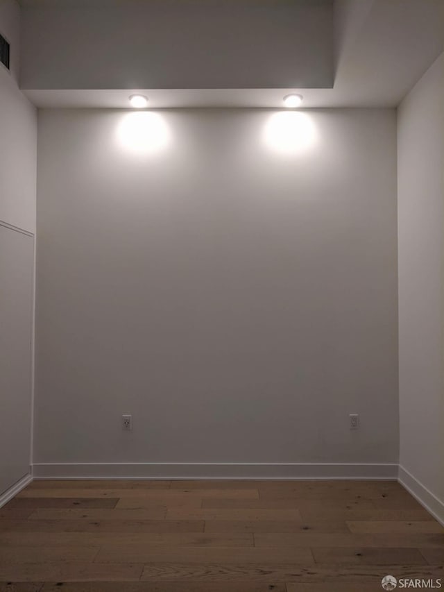 unfurnished room with hardwood / wood-style floors