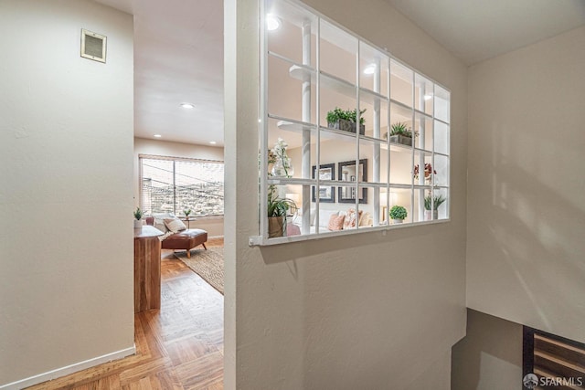 hallway featuring light parquet flooring