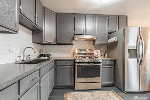 kitchen featuring light stone counters, appliances with stainless steel finishes, gray cabinets, and sink