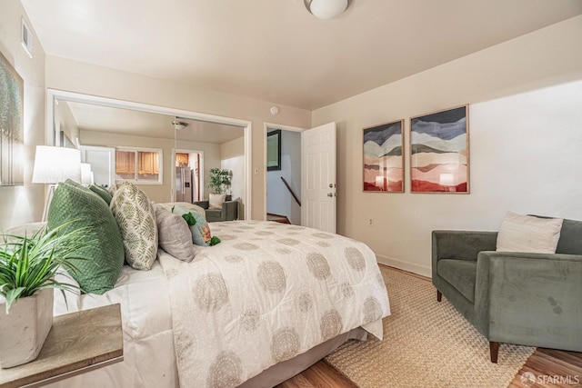 bedroom featuring hardwood / wood-style floors and a closet