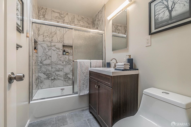 full bathroom featuring enclosed tub / shower combo, vanity, and toilet