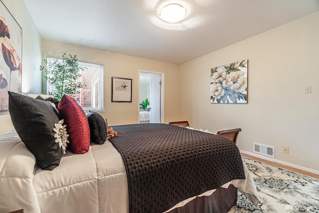 bedroom with hardwood / wood-style floors