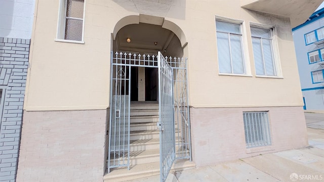 doorway to property featuring brick siding