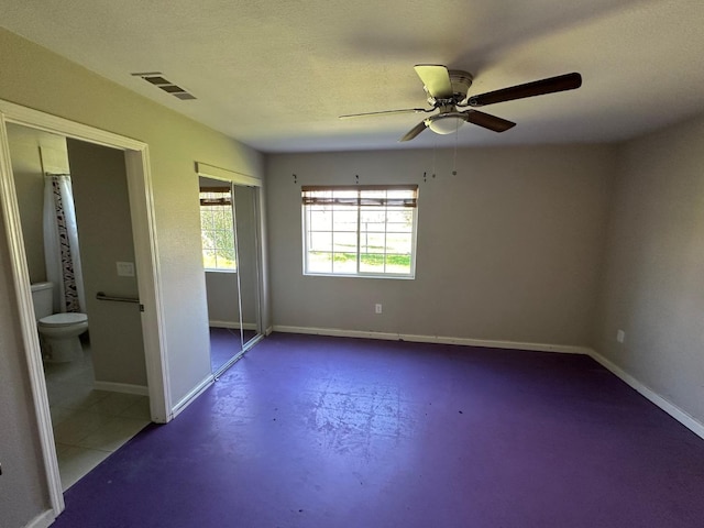 unfurnished bedroom featuring ceiling fan, a closet, a textured ceiling, and concrete floors