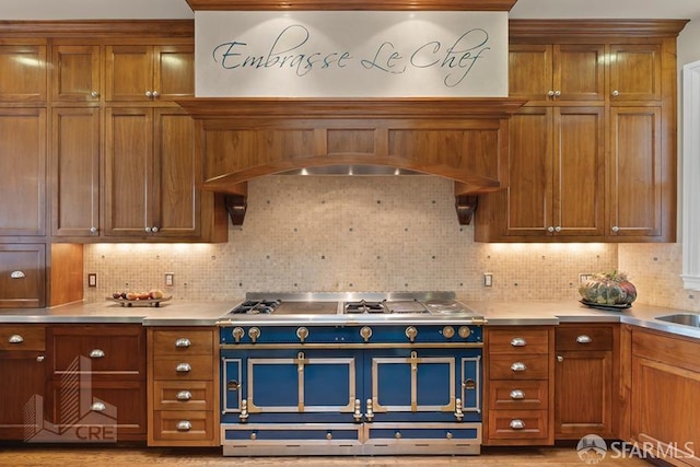 kitchen with decorative backsplash and range with two ovens