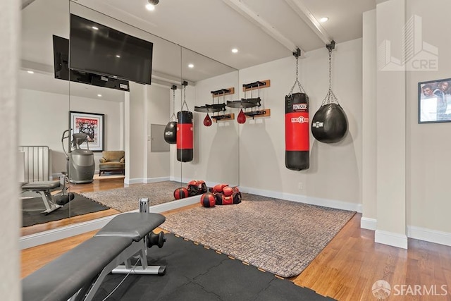 exercise room with hardwood / wood-style floors