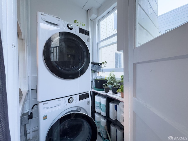 laundry room featuring stacked washer and clothes dryer