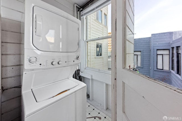 laundry room with stacked washer / dryer