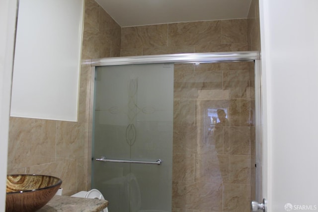 bathroom featuring toilet and walk in shower