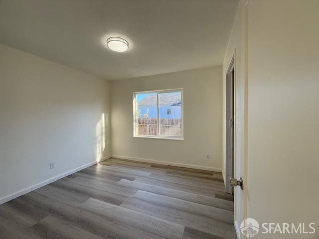 unfurnished room with light hardwood / wood-style floors