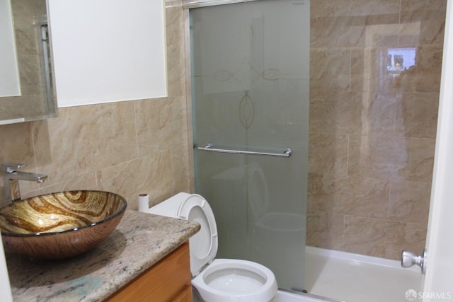 bathroom with vanity, toilet, and an enclosed shower