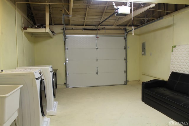 garage featuring a garage door opener, separate washer and dryer, electric panel, and sink