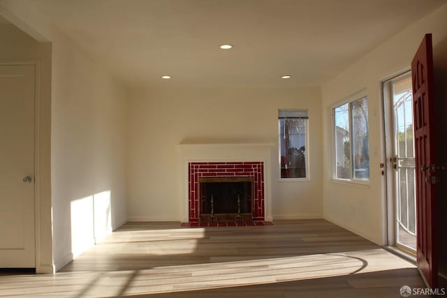 unfurnished living room with light hardwood / wood-style floors and a fireplace