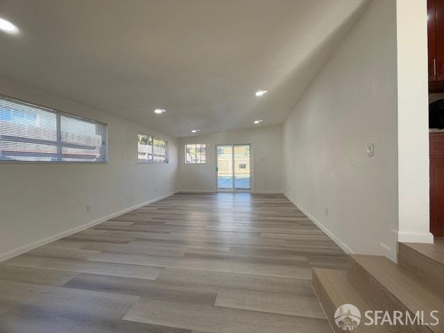 spare room with light hardwood / wood-style floors and a healthy amount of sunlight