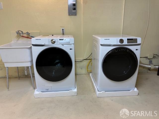 laundry area with sink and separate washer and dryer