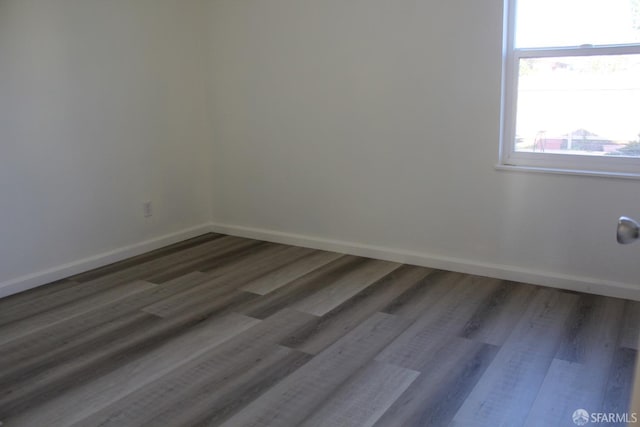 empty room featuring dark hardwood / wood-style flooring