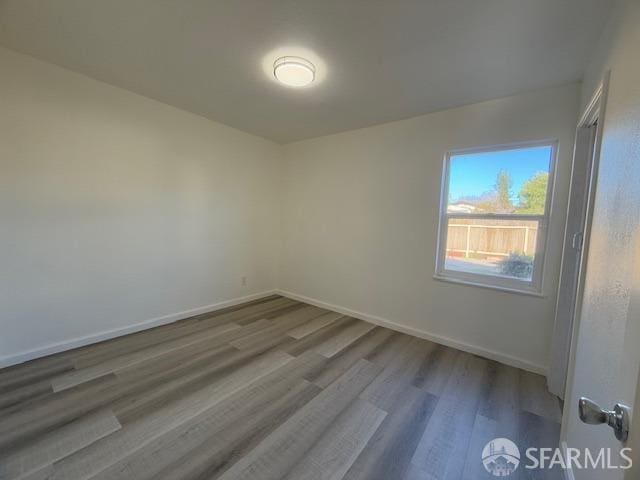 spare room with hardwood / wood-style floors