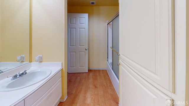 103 Stoneridge Ln Unit 2210, San Francisco, CA 94134 - full bathroom with wood finished floors, a shower with shower door, and vanity