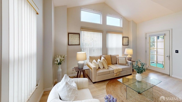 103 Stoneridge Ln Unit 2210, San Francisco, CA 94134 - living area featuring plenty of natural light, light wood-style floors, and high vaulted ceiling