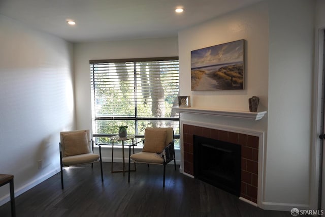 living area featuring recessed lighting, baseboards, wood finished floors, and a tile fireplace