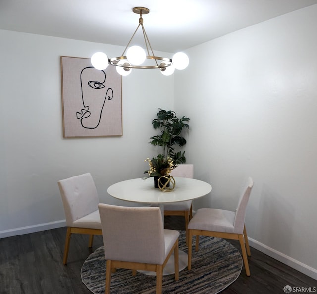 dining area with a chandelier, baseboards, and wood finished floors