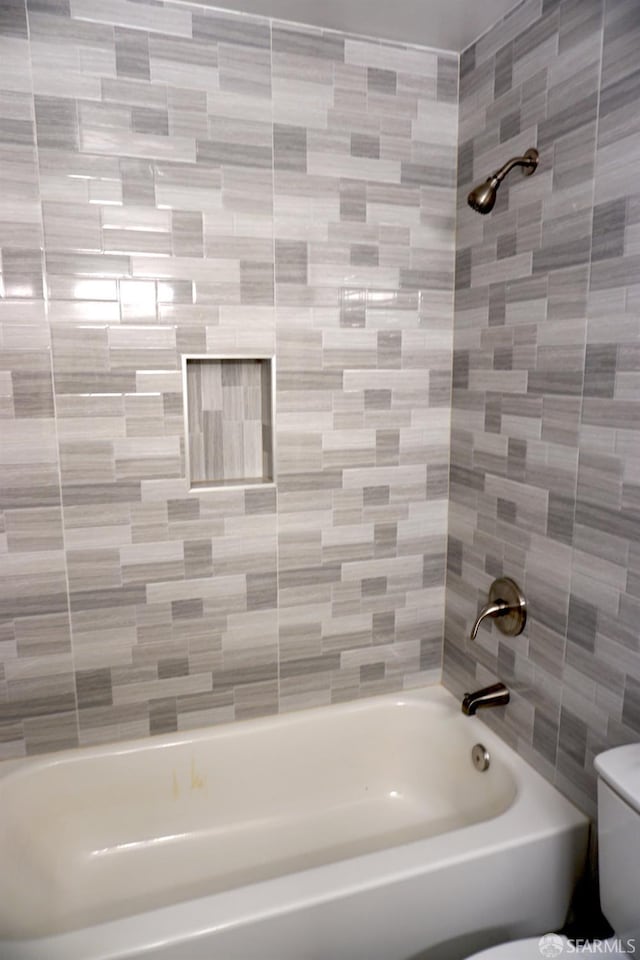 bathroom featuring toilet and shower / bath combination