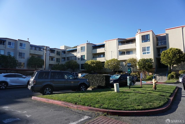 view of building exterior with uncovered parking