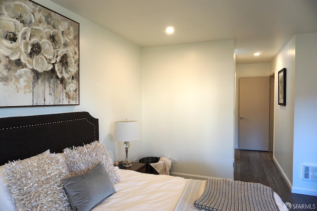 bedroom with recessed lighting, visible vents, baseboards, and wood finished floors