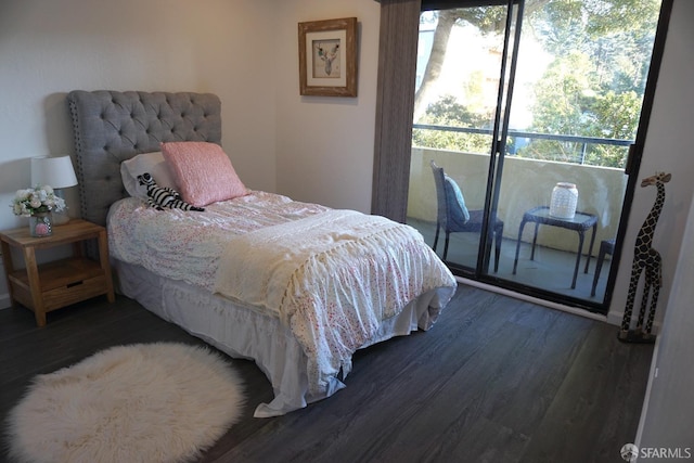 bedroom featuring multiple windows and wood finished floors