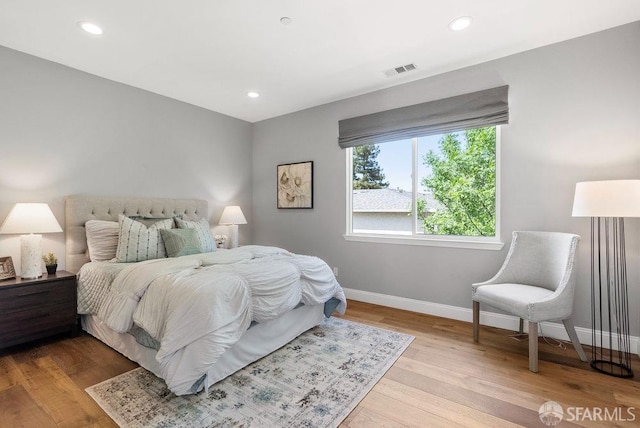 bedroom featuring recessed lighting, baseboards, visible vents, and wood finished floors