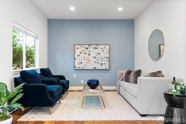 living area with recessed lighting, baseboards, and wood finished floors