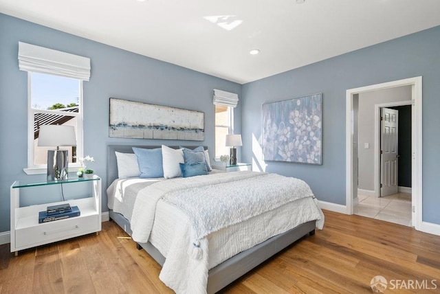 bedroom with baseboards, recessed lighting, and wood finished floors