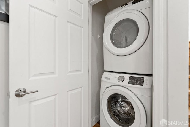 laundry area featuring laundry area and stacked washer / dryer