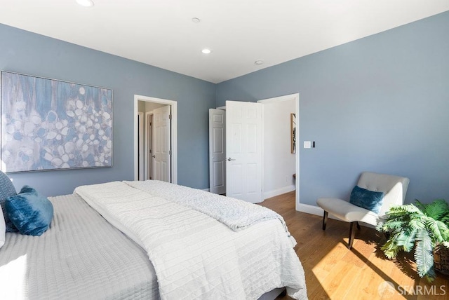 bedroom featuring recessed lighting, baseboards, and wood finished floors