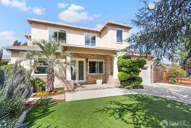 view of front facade featuring fence, a front yard, stone siding, stucco siding, and concrete driveway